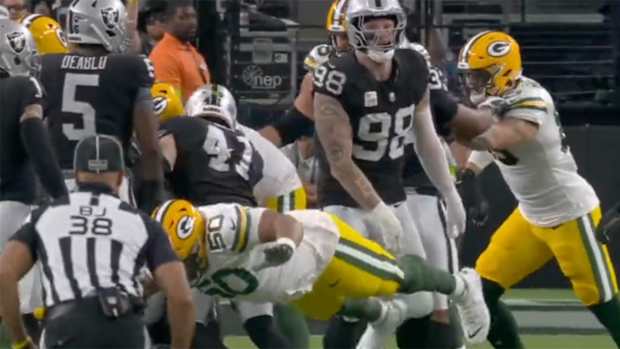 Packers offensive lineman Zach Tom flops after contact from Raiders DE Maxx Crosby.
